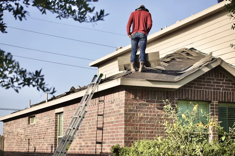Professional roofer working on a residential roof in Apple Mountain Lake